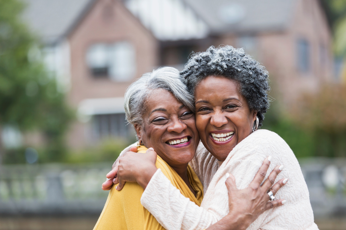 Senior black women embracing